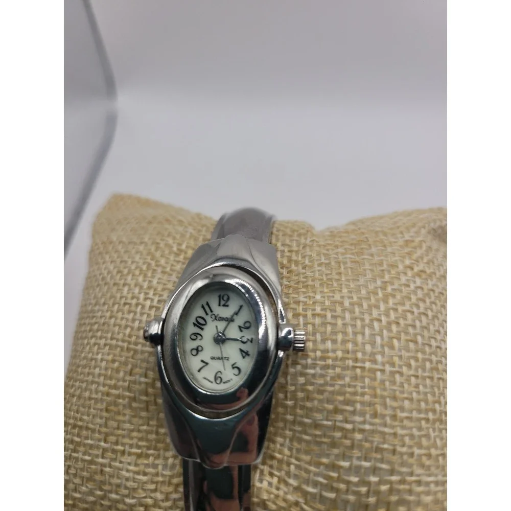 Xanadu Women's Silver Tone Hinged Cuff Bangle Quartz Watch Oval Dial Reverse